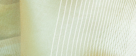 green silk fabric texture, salad coloring. Green silk drapery. Isolated as a whole background.