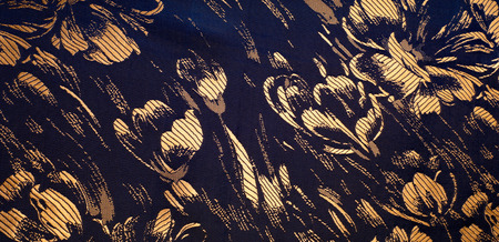 Fabric texture of silk with gold-painted flowers