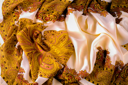texture, pattern. White silk fabric with a brown pattern. A female scarf in Indian design. a drawing of any other name can smell like sweet, but will not look as gorgeous as these patterned silks.の写真素材