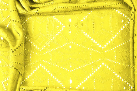texture, pattern. Cloth is yellow dense with perforated holes. Perforated with a delightful design,...