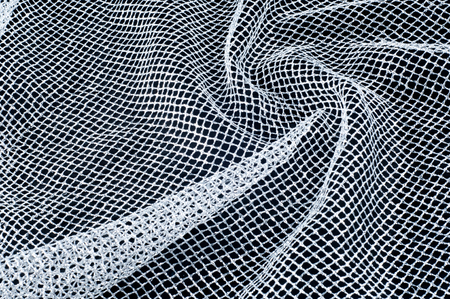 fabric, background texture. White silver mesh fabric, with a woven metallic thread. Silver fashion mesh! Flickering beads add texture and shine to the piece.の写真素材