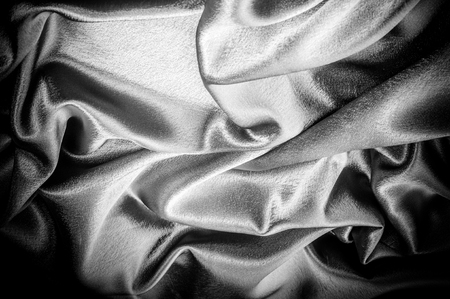 texture, pattern. Fabric made of silk fabric is black, This metallic black abstract jacquard is as magical as a mermaid under the water. The luminous metallic shade is mixed with the spray of colorの写真素材