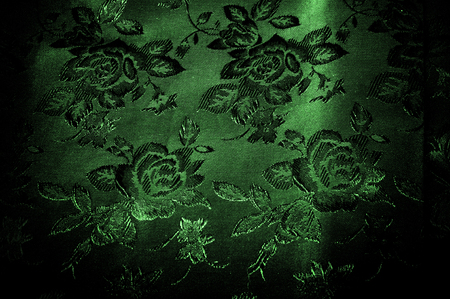 fabric texture. green silky fabric with a pattern of flowers. Printed over a very thin veil consisting of silk and cotton fibers, this material will be a brilliant addition to any vintage design lineの写真素材