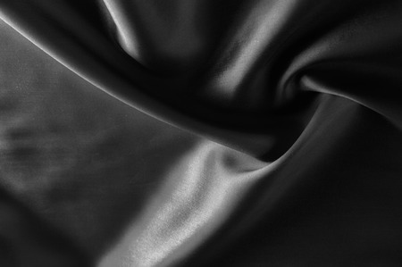 Soft focus cloth silk black. Take home this black washed silk! The washed black color is a soft, silky hand. Thin and light, it has a liquid drape that stands out when creating soft silhouettes.の写真素材