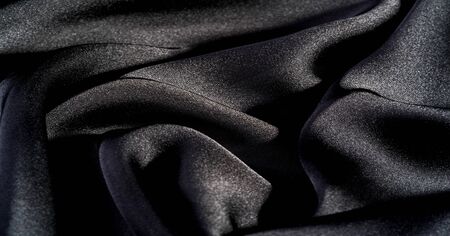 Background, pattern, texture, wallpaper, black silk fabric.  Add a touch of luxury to any design, putting it in this ultra-soft and very lightweight polyester lining fabric.の写真素材