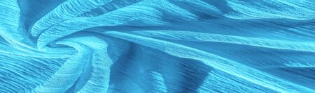Texture, background, pattern, collection, wrinkled silk fabric "electric" blue. 3D pleated wrinkled and wrinkled light camel fabric made of pure silkの写真素材