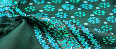silk fabric of green color with blue and white flowers, dense fabric, bilateral on the basis of...