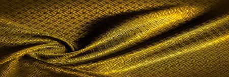 Background texture, pattern. Yellow, mustard silk fabric with a small checkered pattern. Muffled...