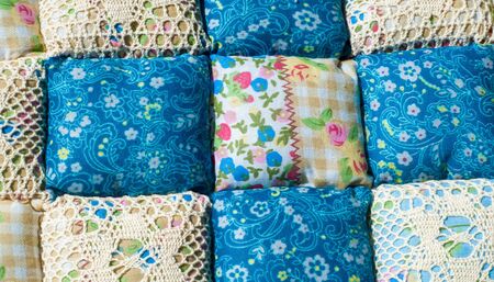 Texture background, pattern. Different fabrics stacked on a table in a pileの写真素材