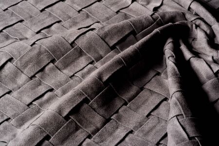 Textured, background, pattern, Woven fabric of intertwined folded strips of gray. Fashionable...