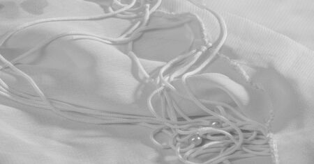 Background, pattern, texture, wallpaper, white silk fabric has a brilliant shine. This is the most versatile fabric. Be creative with beautiful accents of your design.の写真素材