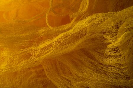 Texture background, pattern. Mesh yellow fabric. Ideal for accents on your design, wallpapers and home decor. Colors include white and yellow.の写真素材