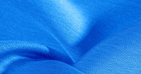 Background, pattern, texture, wallpaper, blue silk fabric. It has a smooth matte finish. Use this luxurious fabric for anything - from design to your projects. The possibilities are truly endless!の写真素材