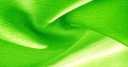 Background, pattern, texture, wallpaper, green silk fabric. It has a smooth matte finish.の写真素材