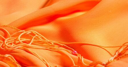 background, pattern, texture, Orange silk fabric has a brilliant luster. It folds into soft folds when draping and is the most versatile fabric. Be creative with beautiful accents of your design.の写真素材