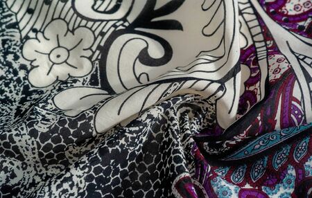 Background texture. cotton women scarf black and white pattern on one side of the scarf and color...