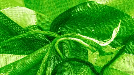 Texture background pattern silk scarf female green in color with a metal stripe The scarf is decorated with a delicate patchwork pattern in pastel colors with abstract Scottish motifs checked fabricの写真素材