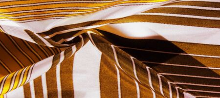 Texture, background, silk fabric with a yellow striped pattern.の写真素材