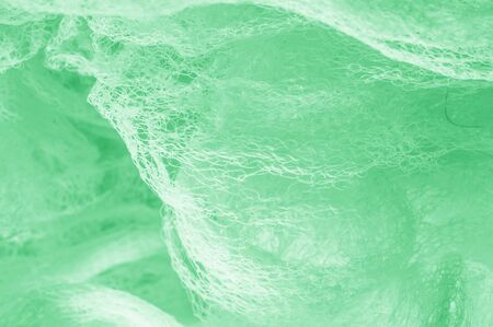 Cloth in a mesh green. Add a line of ethereal brilliance to your decorations and design, Tons of tiny sparkles glitter into the threads to give this fabric a rich, rich and bright tone.の写真素材