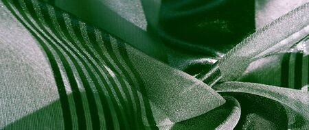Texture, background, pattern, collection, light transparent silk fabric with stripes of different size, green.の写真素材
