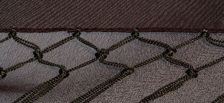 Background texture of silk fabric. This is a natural brown scarf, this beautiful nylon satin made of...