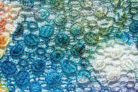 background texture; pattern. Cloth with glued lace stripes. Multicolored lace with sparkles; cording...