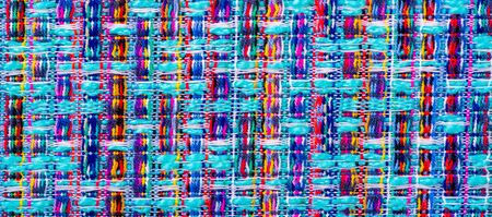 Background texture, pattern. Winter fabric, warm. big braided thread. Blue-red yellow threads. This...