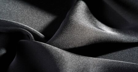 Background, pattern, texture, wallpaper, black silk fabric.  Add a touch of luxury to any design, putting it in this ultra-soft and very lightweight polyester lining fabric.の写真素材
