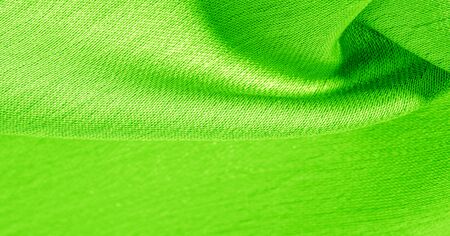 Background, pattern, texture, wallpaper, green silk fabric. It has a smooth matte finish. Use this luxurious fabric for anything - from design to your projects. The possibilities are truly endless!の写真素材