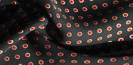 Texture background, pattern,  black silk fabric with red polka dots. Light and silky-soft satin...