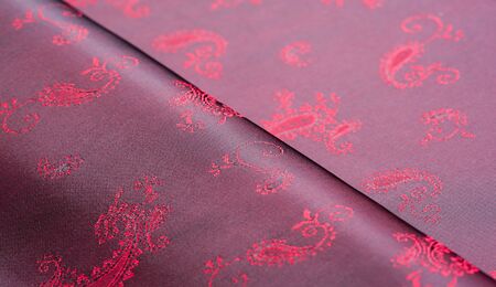 Texture, fabric, red silk with paisley pattern. This beautiful printed silk Charmeuse has a bold...