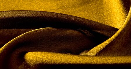 Background, pattern, texture, wallpaper, yellow silk fabric. Add a touch of luxury to any design by adding it to this ultra-soft and very lightweight polyester lining fabric.の写真素材