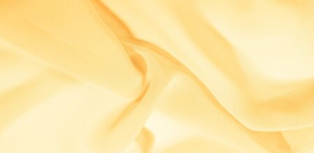 texture background pattern. Yellow silk fabric with a subtle matte sheen. It is perfect for your...