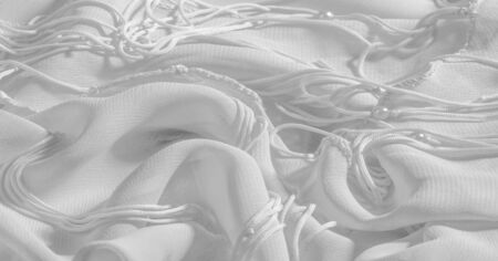 Background, pattern, texture, wallpaper, white silk fabric has a brilliant shine. This is the most...