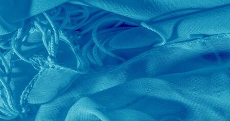 The background, pattern, texture, wallpaper, blue pale silk fabric has a brilliant shine. This is the most versatile fabric. Be creative with beautiful accents of your design.の写真素材