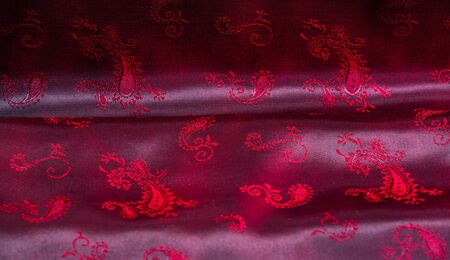 Texture, fabric, red silk with paisley pattern. This beautiful printed silk Charmeuse has a bold...