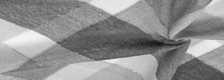 Texture, background, silk scarf feminine black and white with a metal stripe. The scarf is decorated...