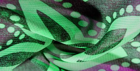 texture background pattern wallpaper. Green pink black silk fabric pattern. This medium-weight rayon fabric has a nice shine with slight color variations. Perfect for adding elegance to your designsの写真素材