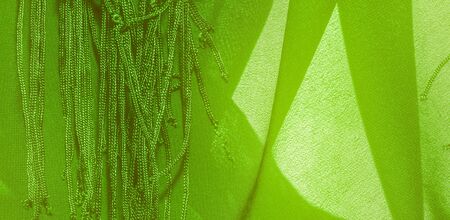 Background texture of silk fabric. This is a natural green salad scarf, this beautiful nylon satin...