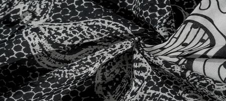 Background texture. cotton women scarf black and white pattern on one side of the scarf and color...