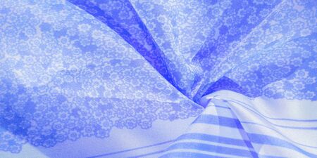 Texture, pattern, blue silk fabric on a white background, flowers pattern silhouette on white background decorative course, postcard wallpaper design. Your project will be successful. Act inspiredの写真素材