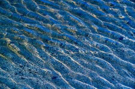 Summer landscape. Light breeze, small waves, reflections of the sun's rays at the bottom of the sandy bottom,の写真素材