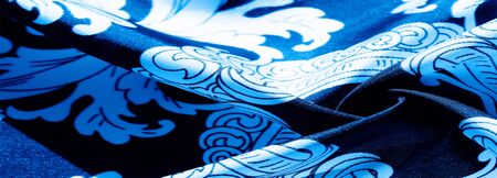 texture, background, black silk fabric with a monogram pattern Exquisite pattern of filigree fabric...