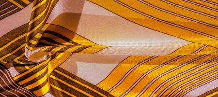 Texture, background, silk fabric with a yellow striped pattern. The design of this fabric is...