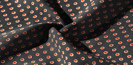 Texture background, pattern,  black silk fabric with red polka dots. Light and silky-soft satin charm is ideal for your design, Internet projects. It is also perfect for screensavers and wallpapers.の写真素材