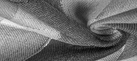 Texture, background, silk scarf feminine black and white with a metal stripe. The scarf is decorated with a delicate patchwork pattern in pastel colors with abstract Scottish motifs. checked fabricの写真素材