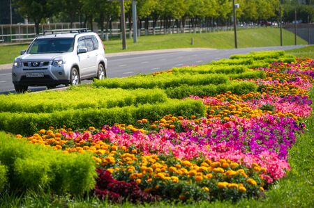 City photo, Flowerbeds in the city, in the background motorway with cars, Russia Naberezhnye Chelny 18,08,2018gのeditorial素材