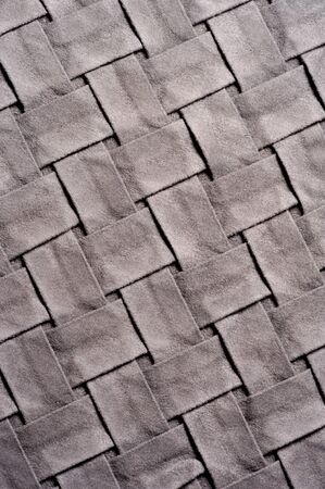 Textured, background, pattern, Woven fabric of intertwined folded strips of gray. Fashionable...