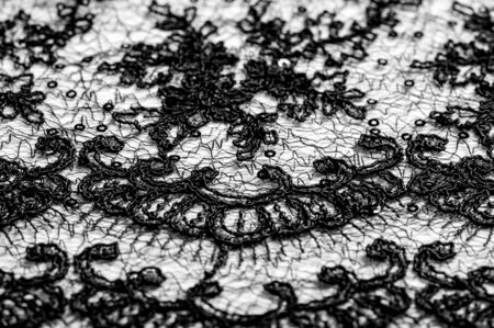 Texture, pattern, lace fabric in black on a white background. This beautiful double Gallon woven fabric is crisp and versatile, with a moderate amount of draped and floral motifs.の写真素材