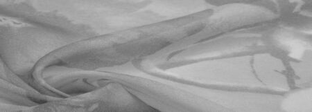 Texture, background, white silk with gray floral ornament. The fabric has a jacquard weave, thanks to which it received a lot of satin sections that gently twinkleの写真素材